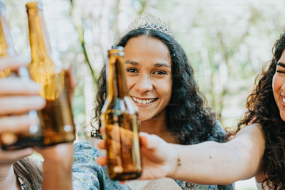 a couple of women holding up bottles of beer