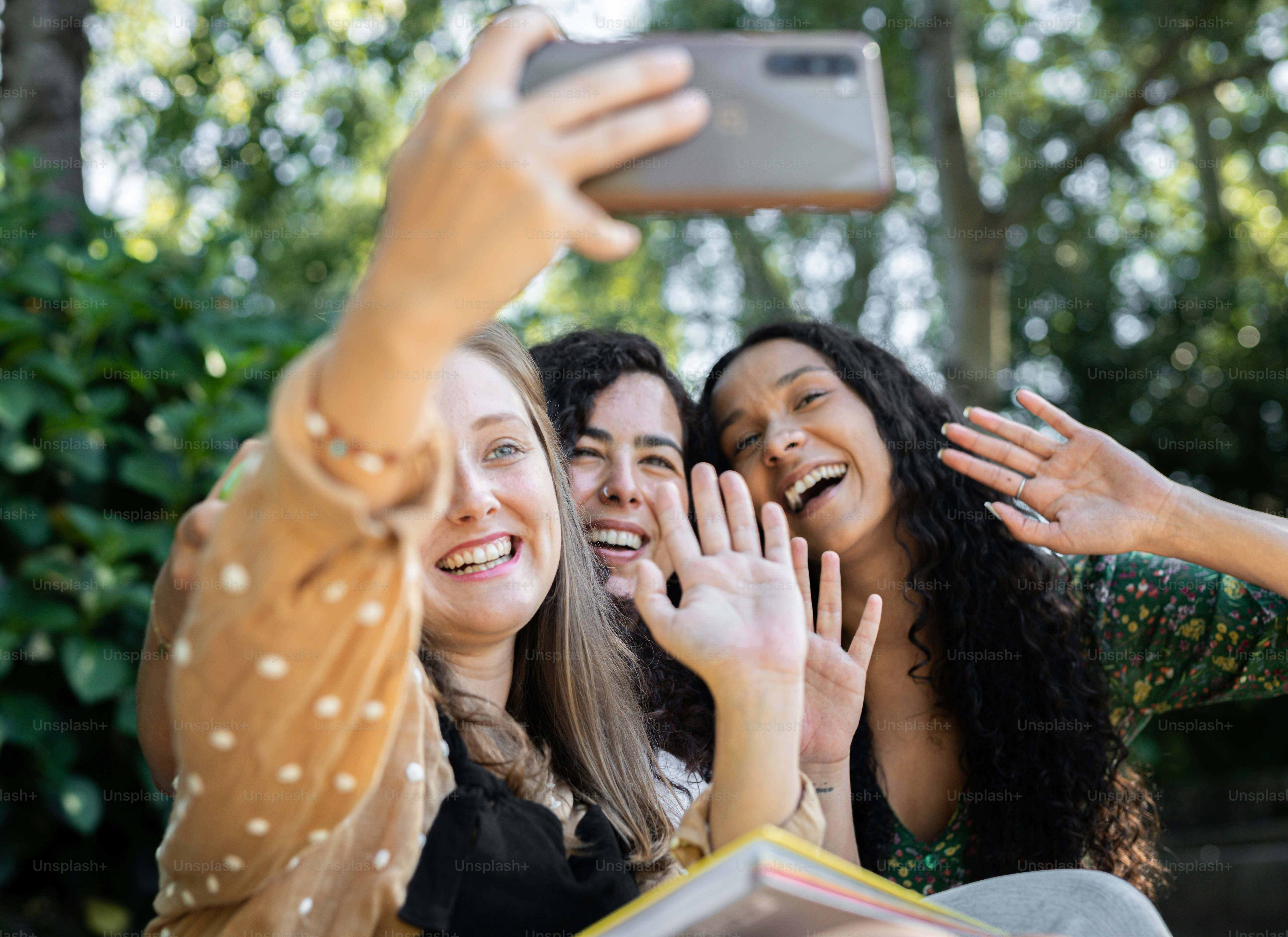 a group of women taking a picture with a cell phone