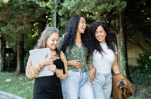 a group of three women standing next to each other