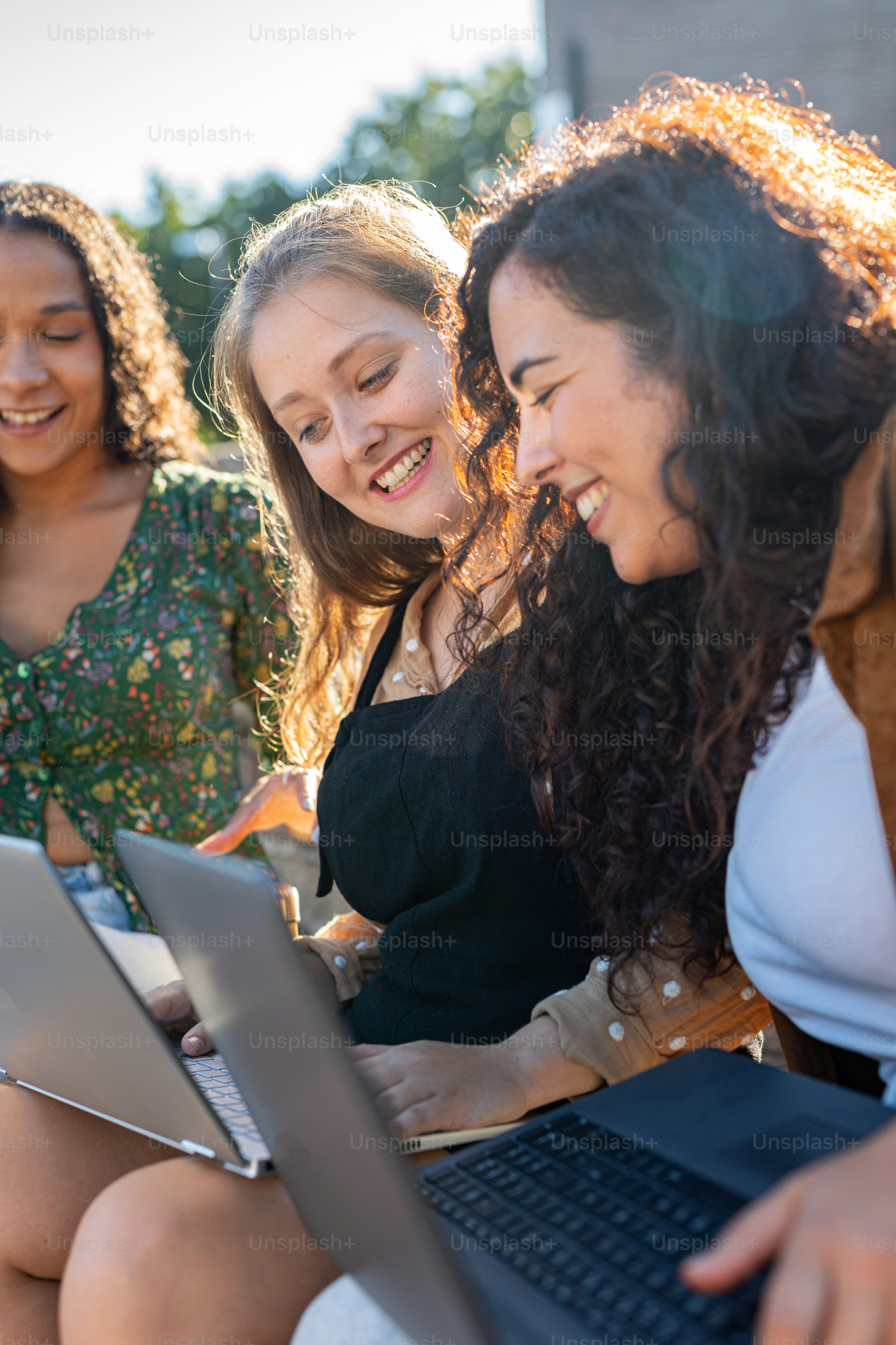 a group of women sitting next to each other on a bench