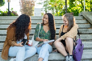 a group of young women sitting next to each other on a bench