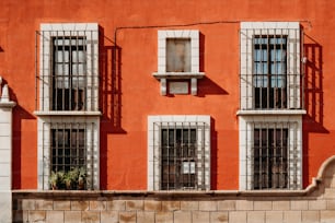 a red building with windows and bars on it