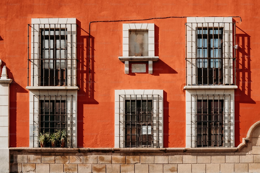 a red building with windows and bars on it