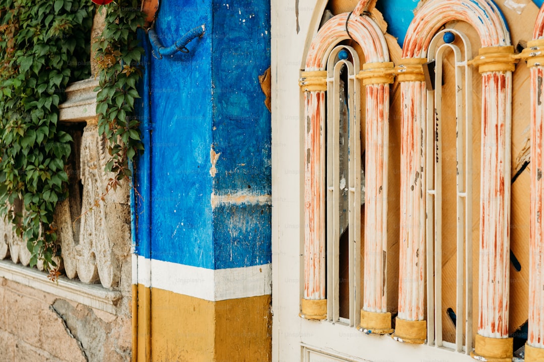 a blue and yellow building with a window