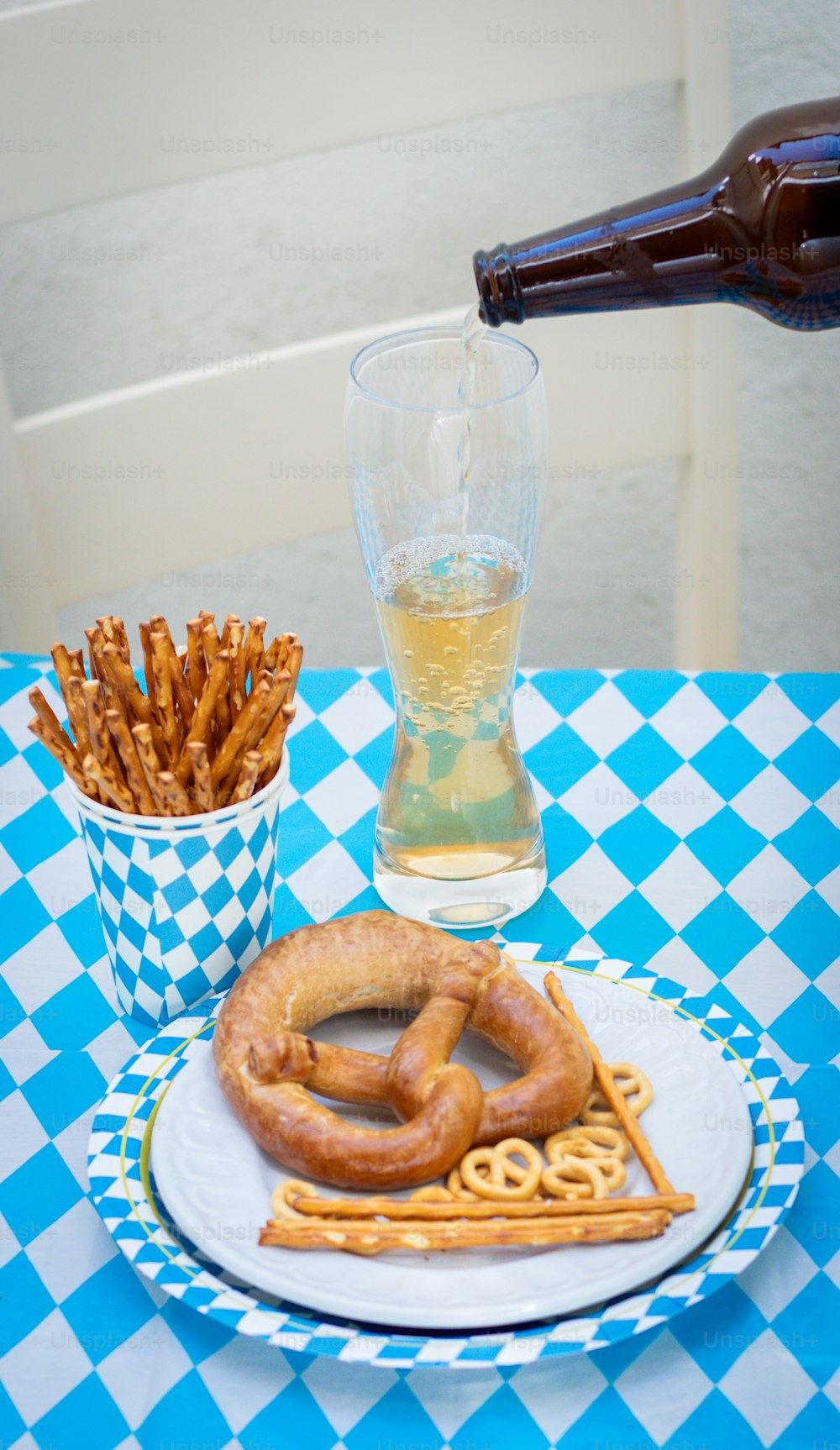 a plate of pretzels and a glass of beer