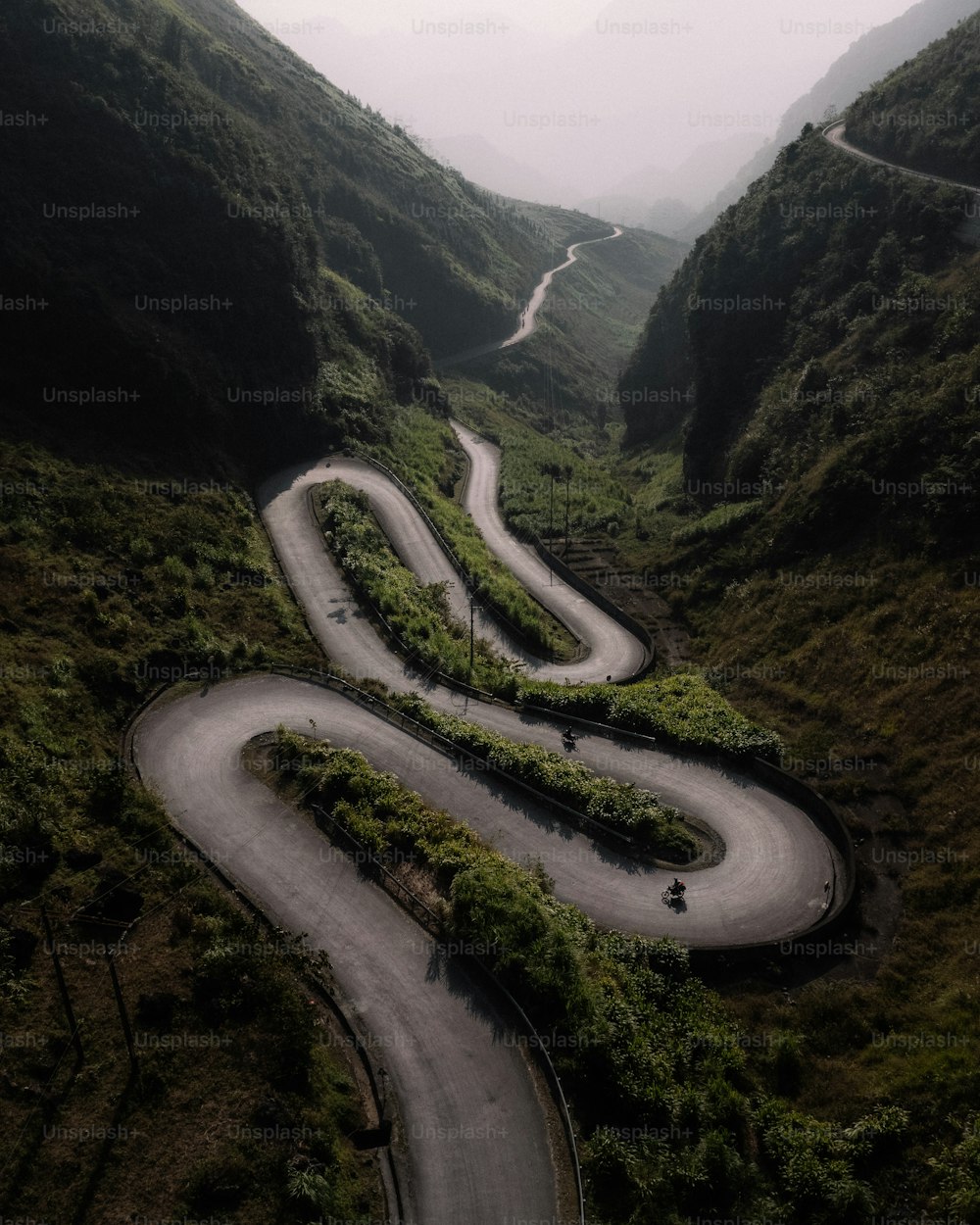 a winding road in the middle of a mountain