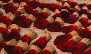 a large group of red and yellow books laying on top of each other