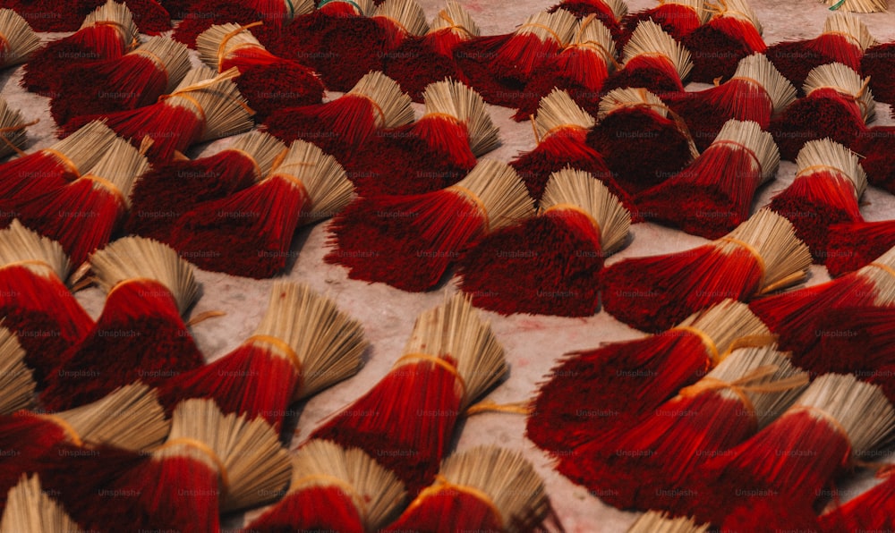 a large group of red and yellow books laying on top of each other