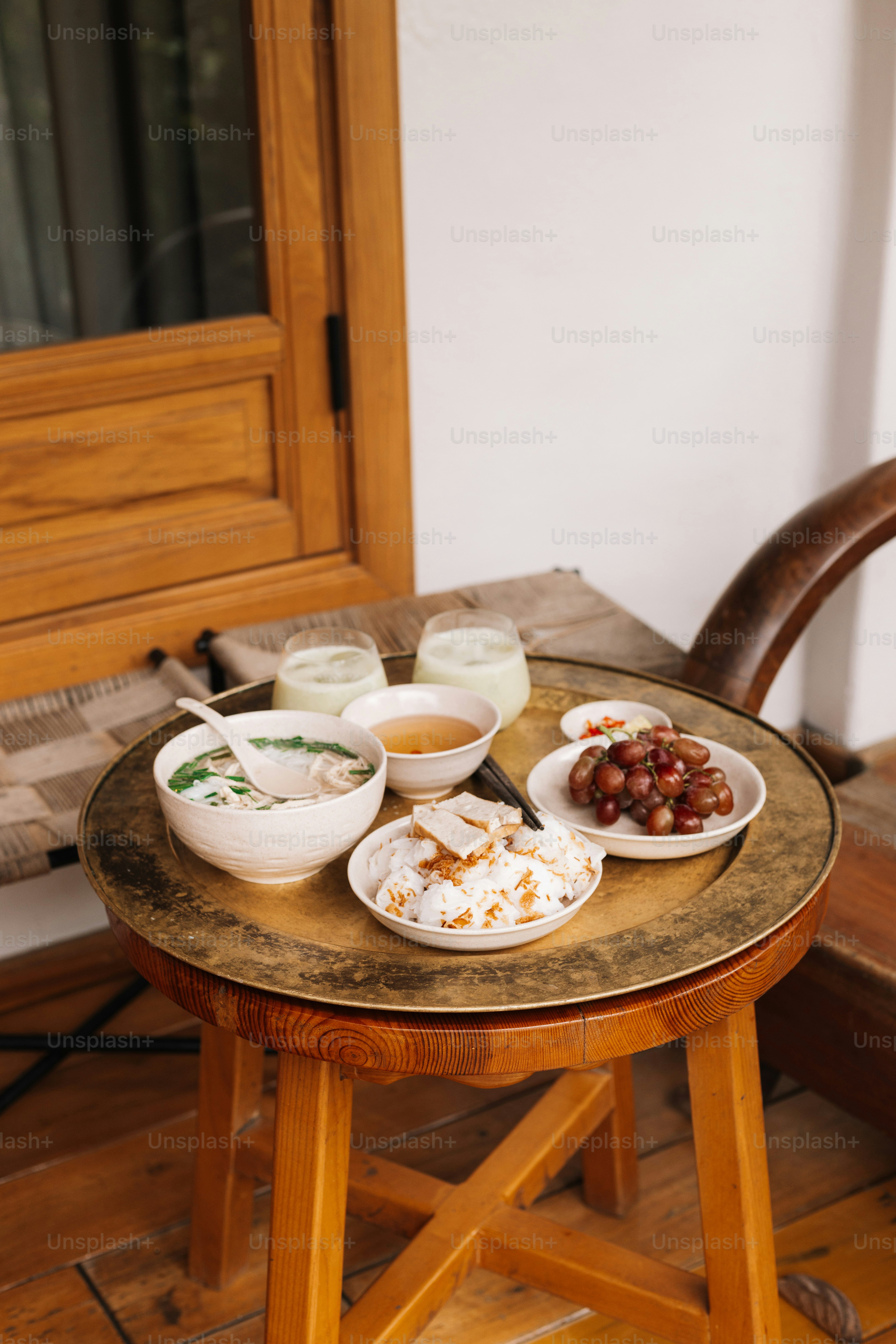 a wooden table topped with plates of food