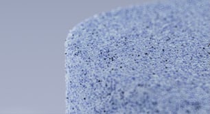 a close up of a blue surface with small dots