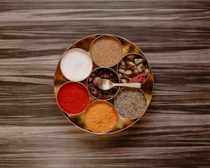 a bowl of spices on a wooden table