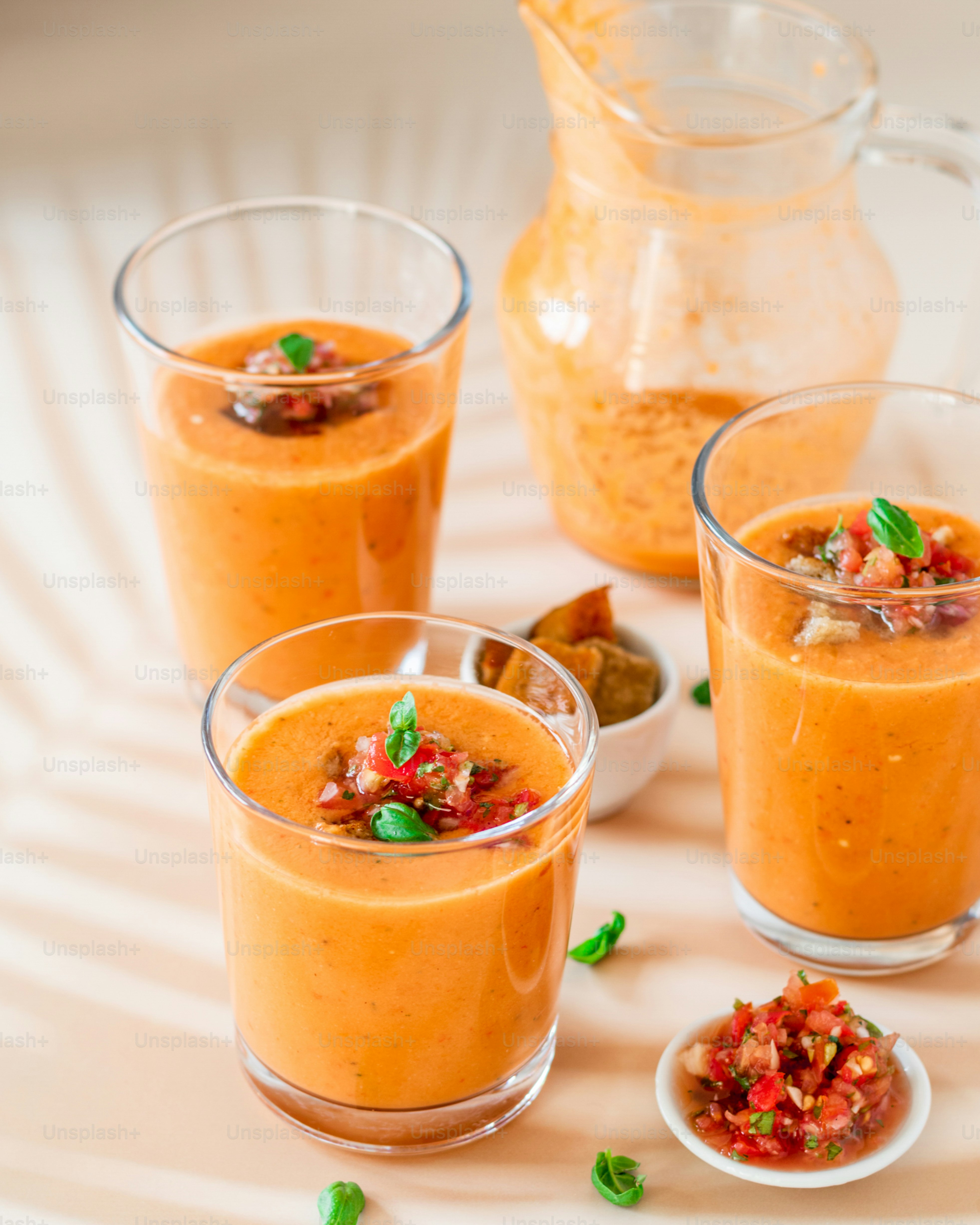 a table topped with three glasses filled with food