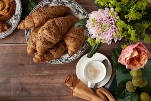 a table topped with plates of pastries and a cup of coffee