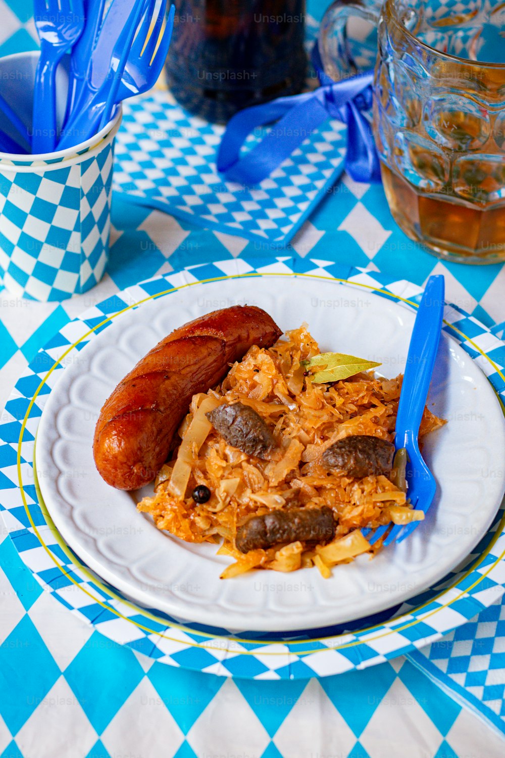 a plate of food on a blue and white checkered table cloth