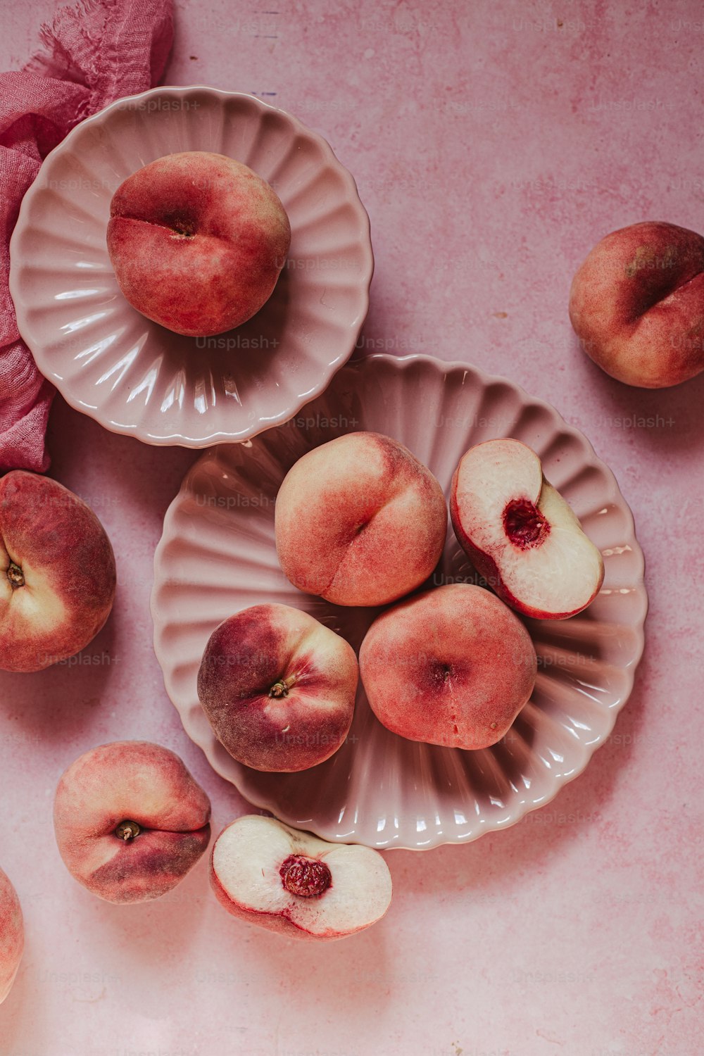 a table topped with plates filled with sliced peaches