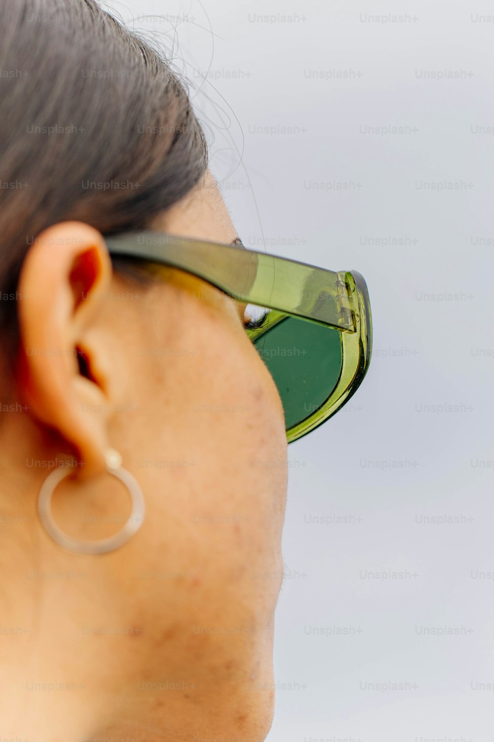 a close up of a person wearing a pair of sunglasses