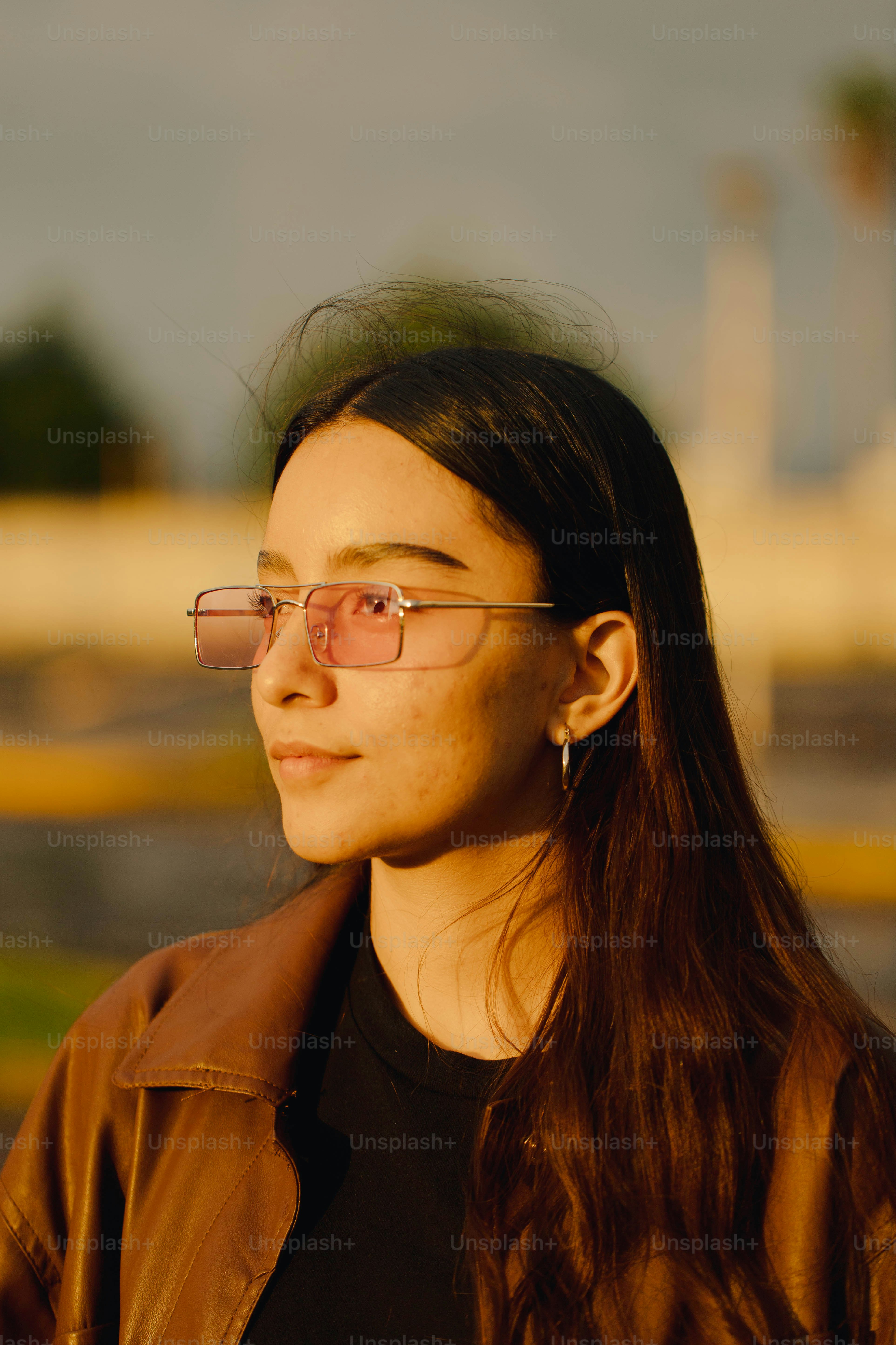 Eine Frau mit Brille und brauner Jacke