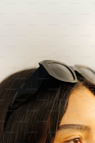 a close up of a person with a pair of sunglasses on their head