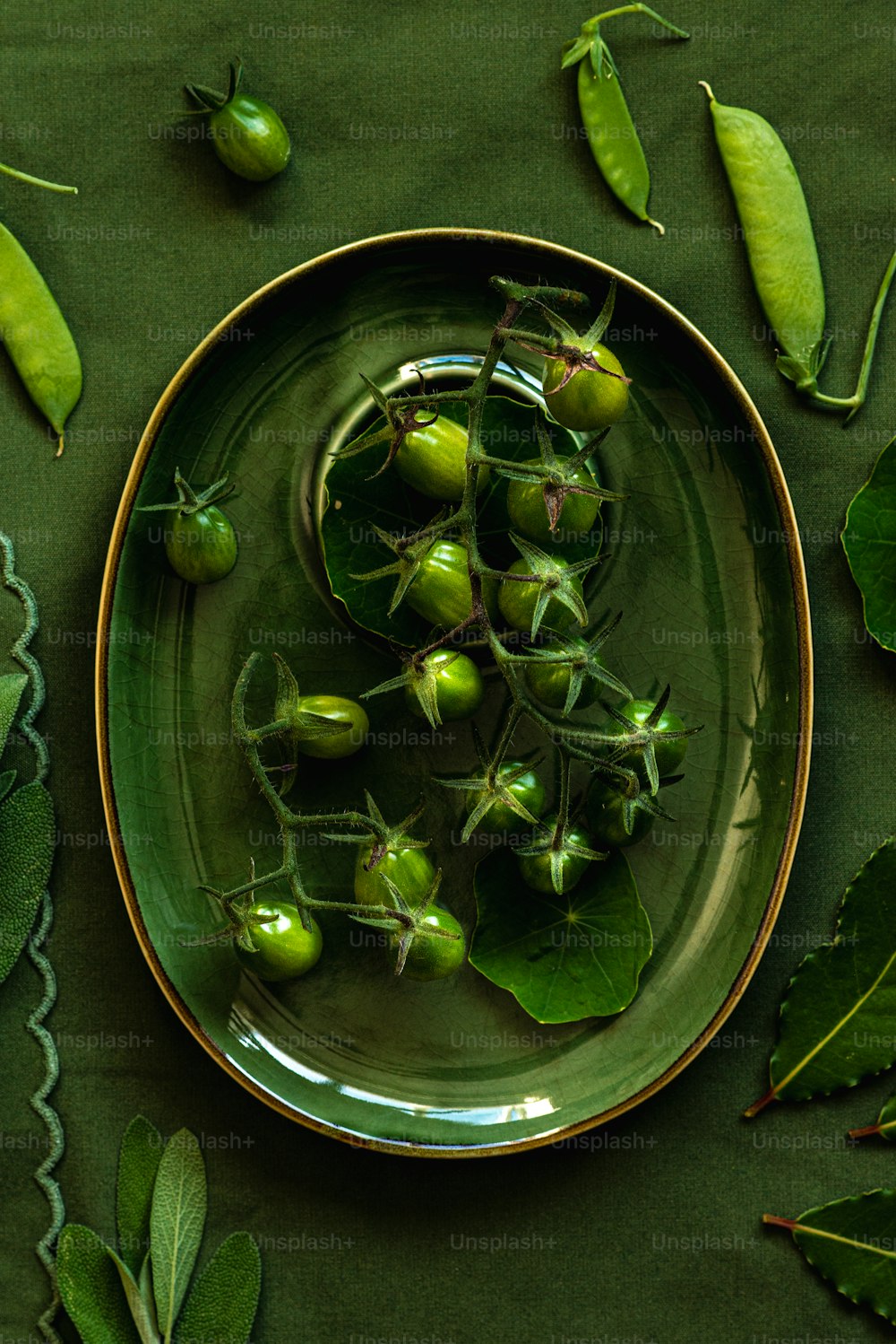 Un plato de verduras verdes sobre un mantel verde