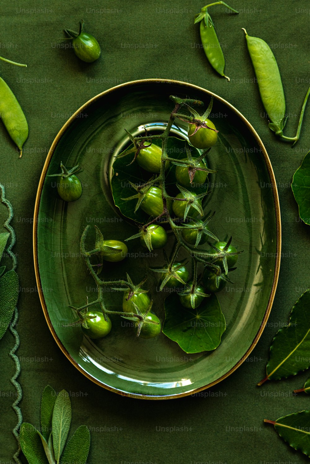 a plate of green vegetables on a green table cloth