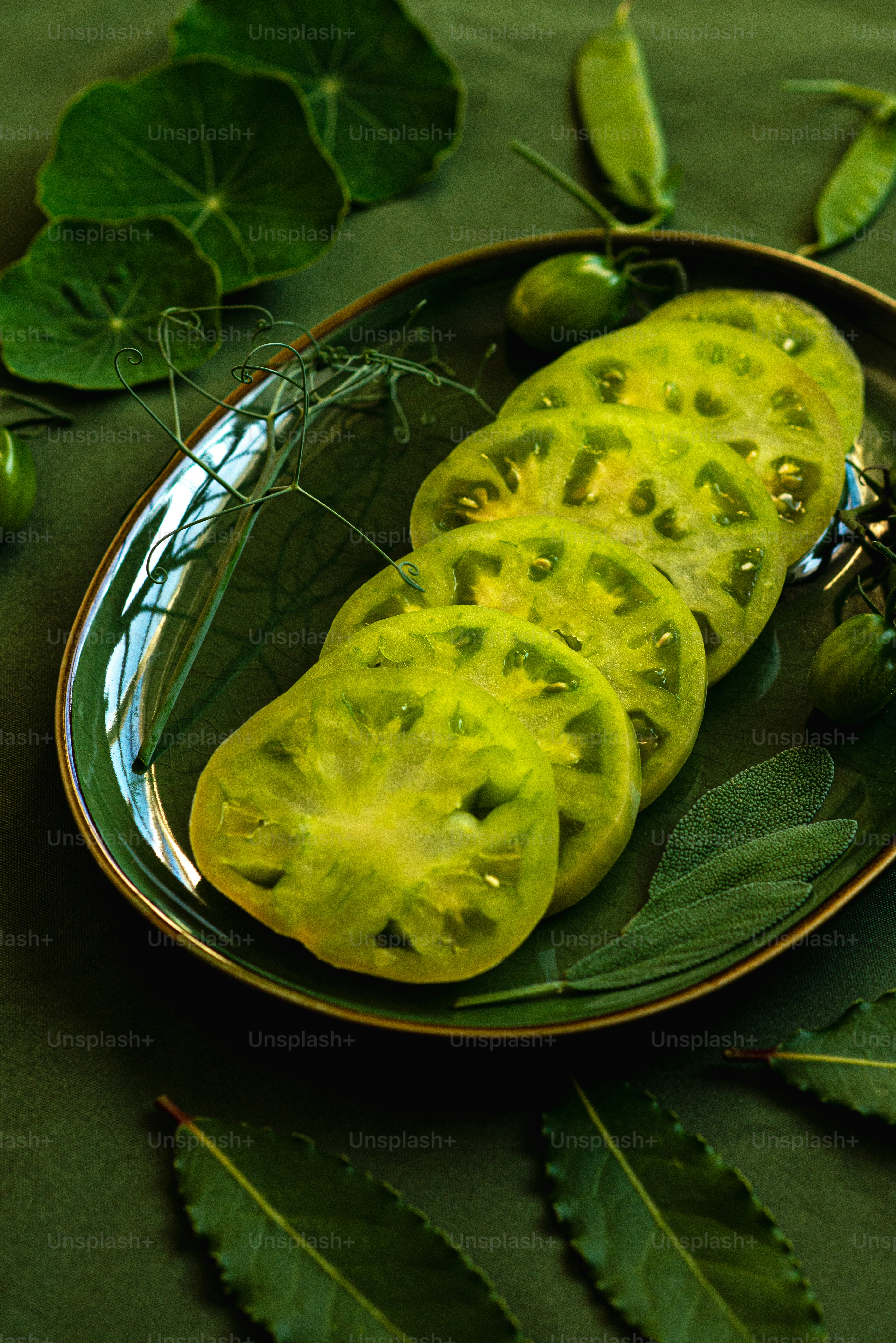 a plate of sliced jalapenos on a green table cloth