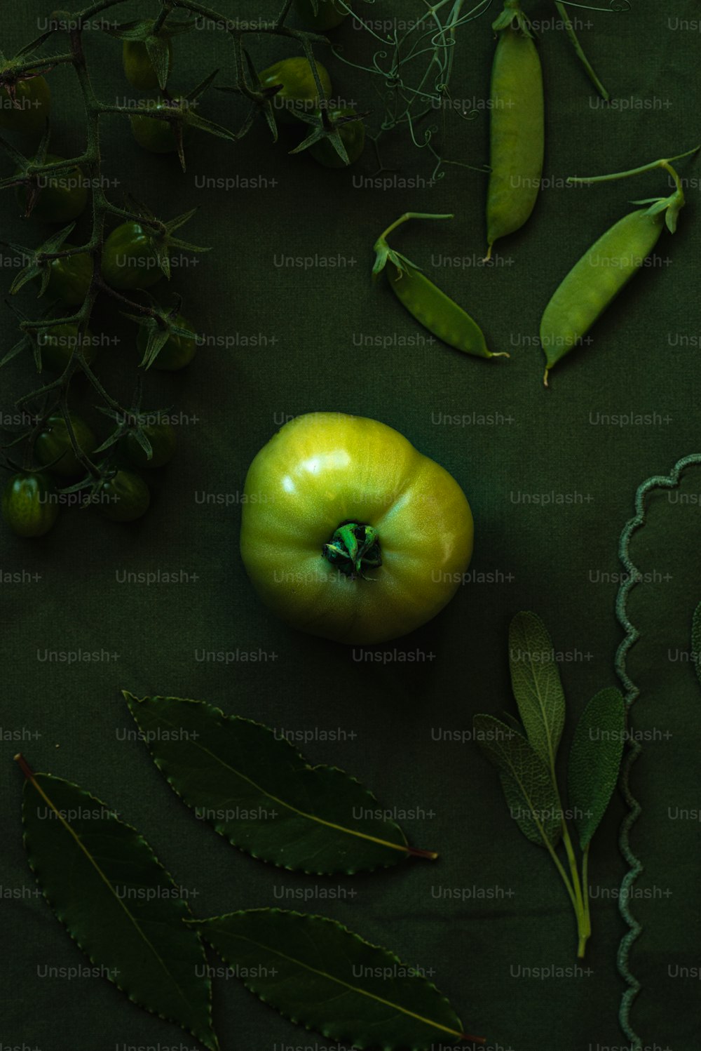 a green apple sitting on top of a green table