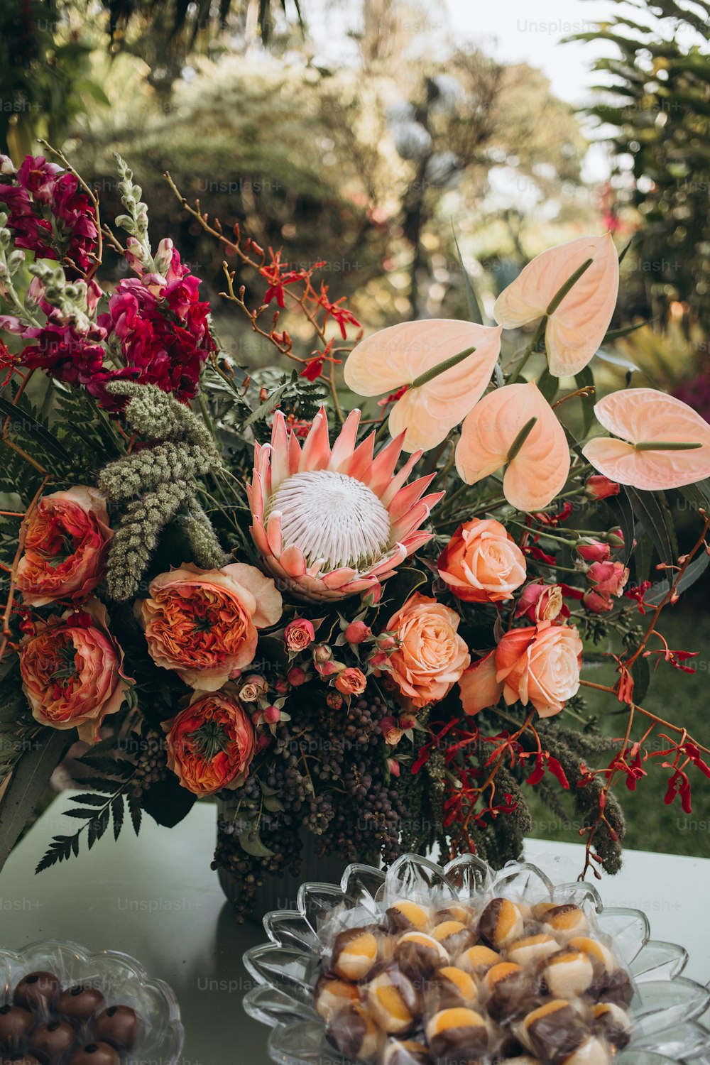 ein Tisch mit einer Vase, die mit Blumen gefüllt ist