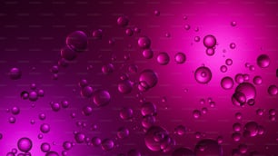 Un montón de gotas de agua sobre un fondo púrpura y rosa