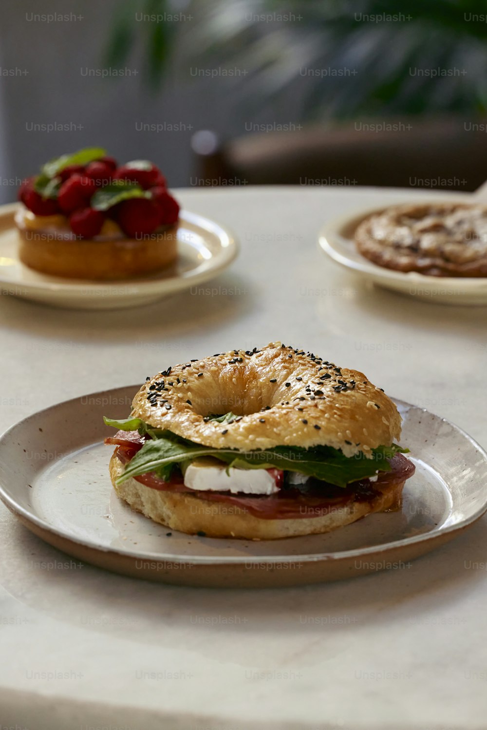 a bagel sandwich on a plate on a table