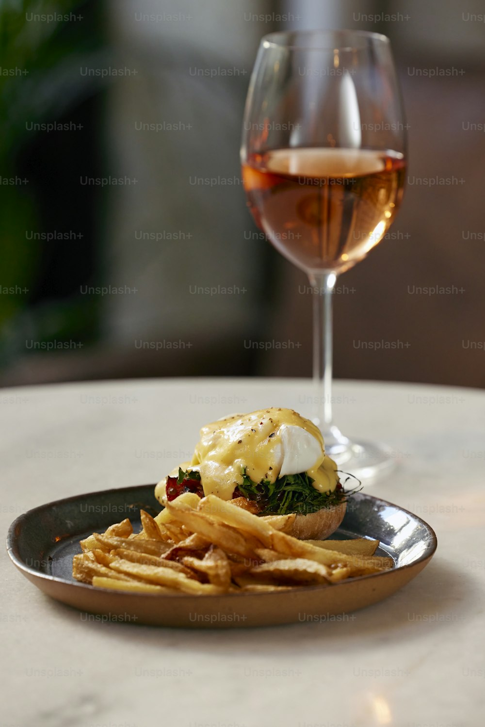 a plate of food and a glass of wine on a table