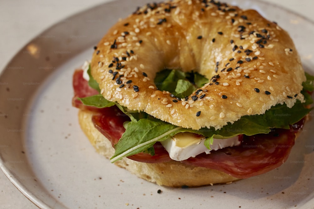 a bagel sandwich on a white plate