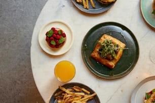 a table topped with plates of food and drinks