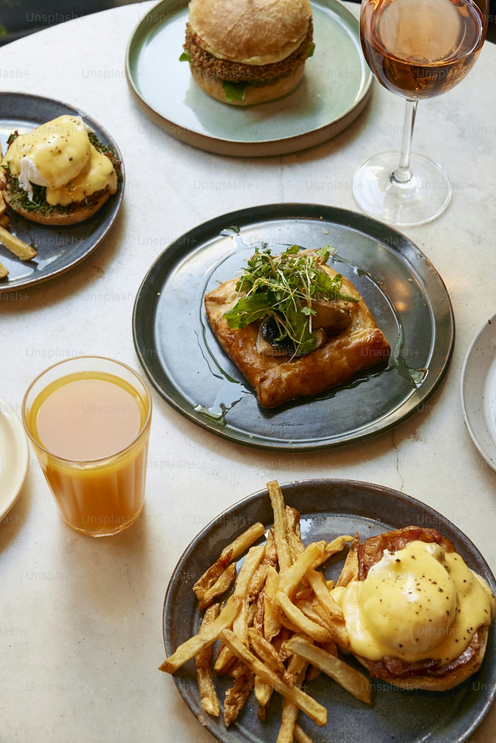 a table topped with plates of food and drinks