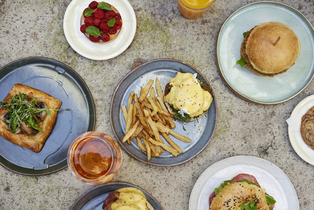 a table topped with plates of food and drinks