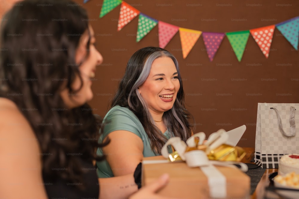 a woman sitting at a table with a box of food