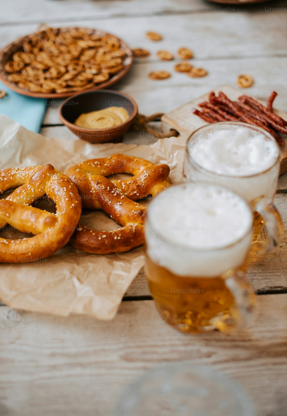 a table topped with pretzels and beer