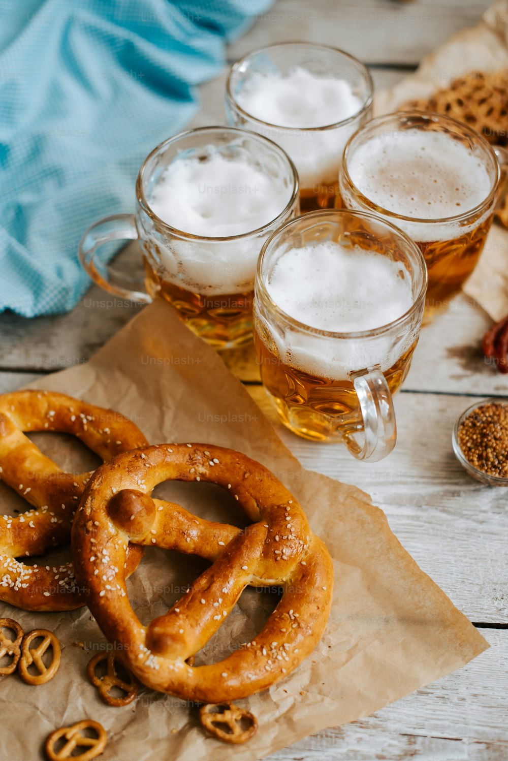 a table topped with pretzels and mugs of beer