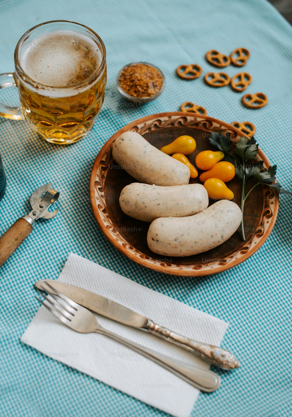 a plate of food on a table next to a glass of beer