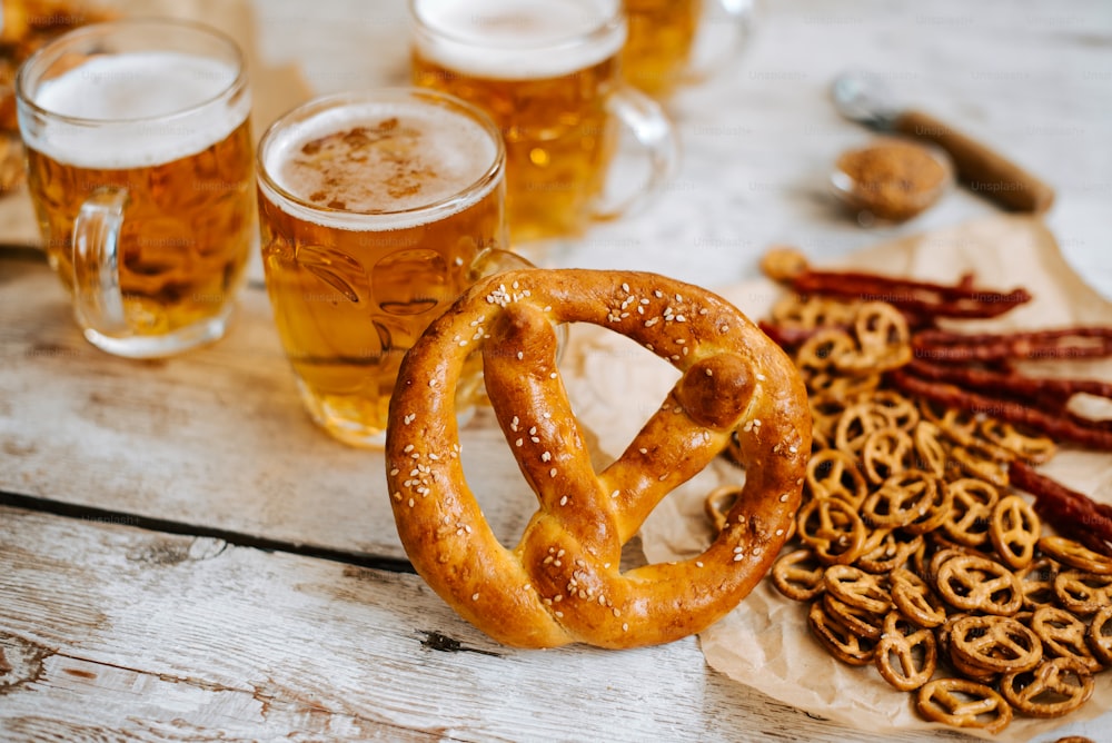 pretzels, pretzels, and beer are on a table