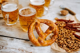 pretzels, pretzels, and beer are on a table