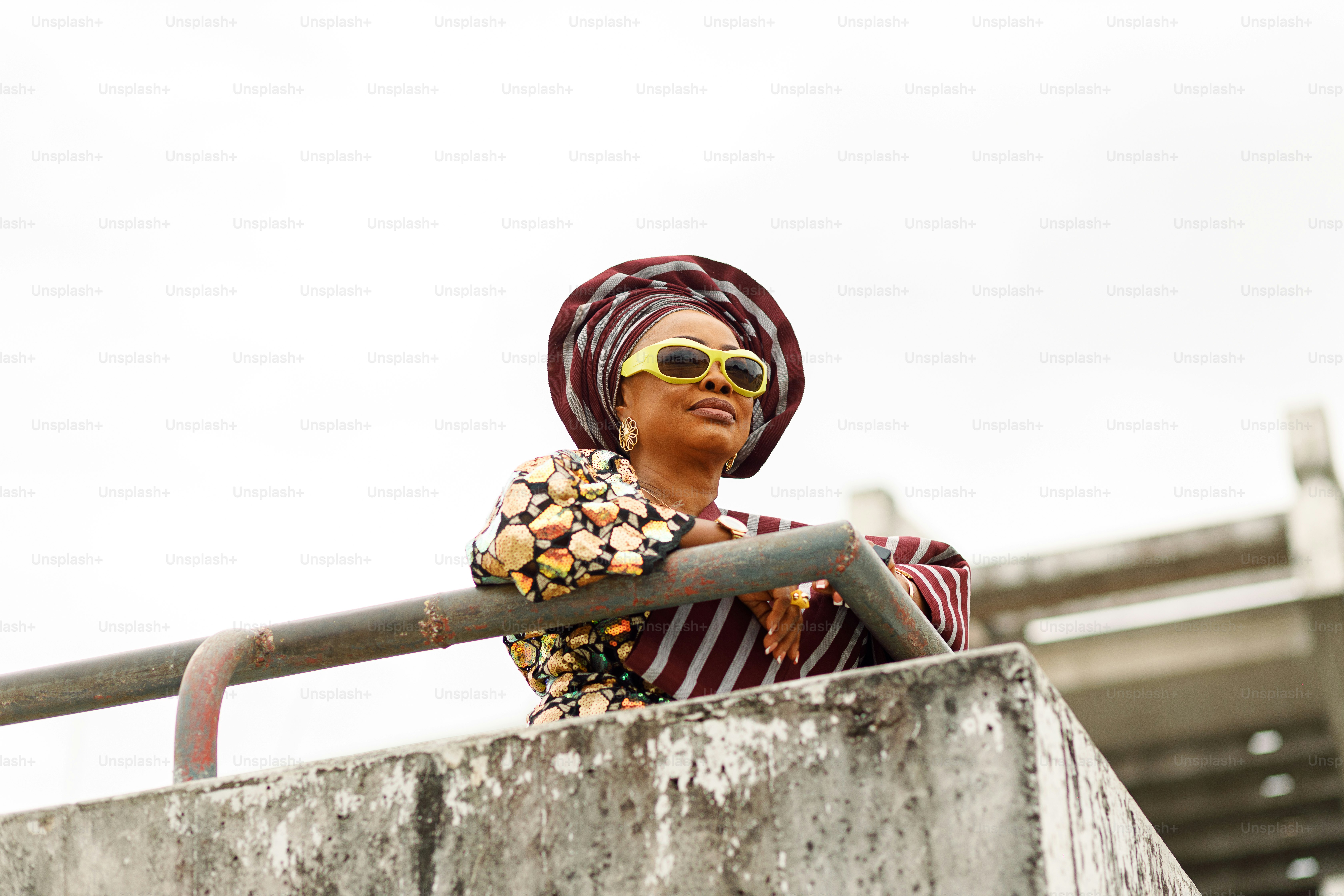a woman wearing sunglasses and a head scarf