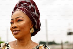 a woman wearing a red and white head scarf