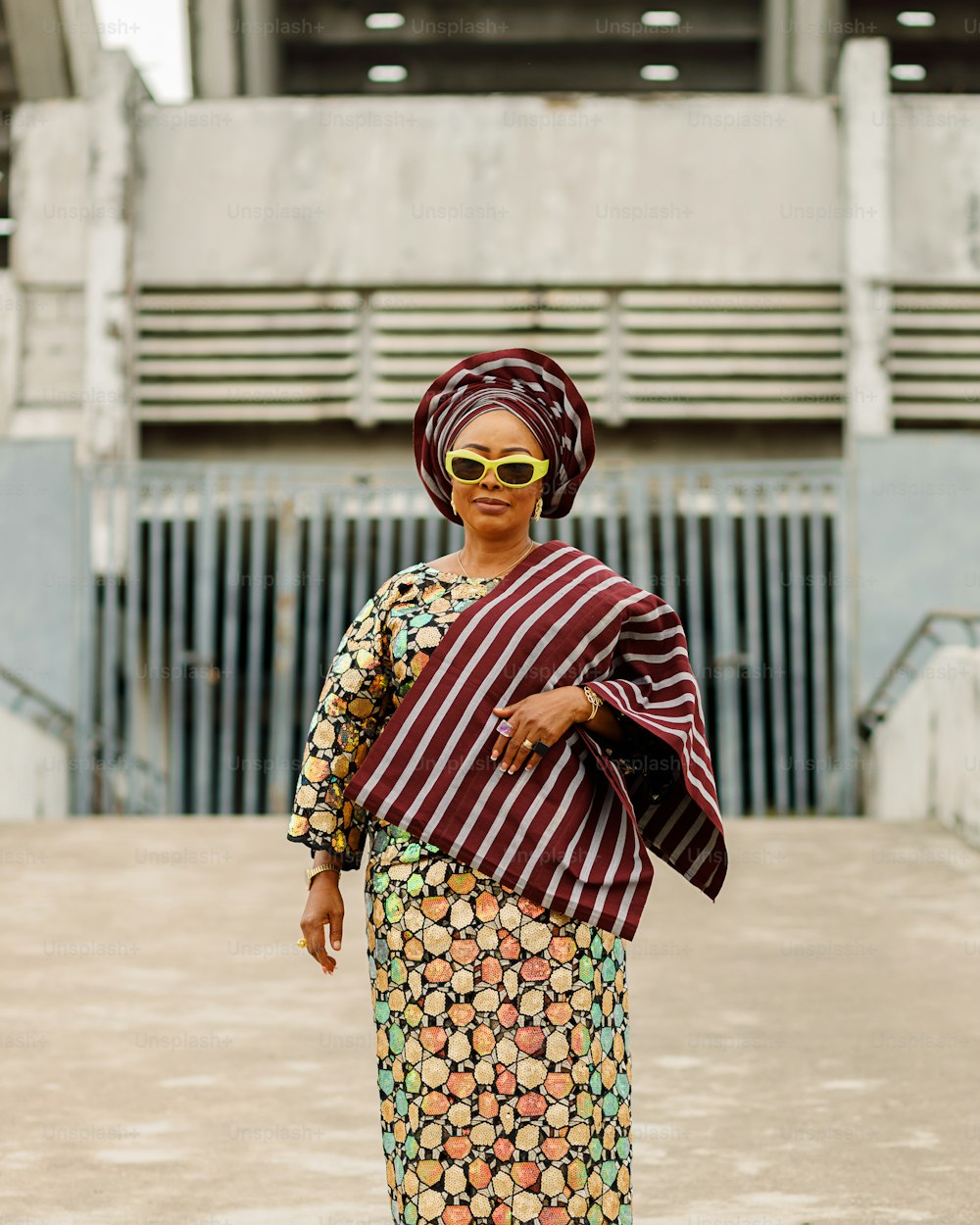 a woman wearing a colorful dress and sunglasses