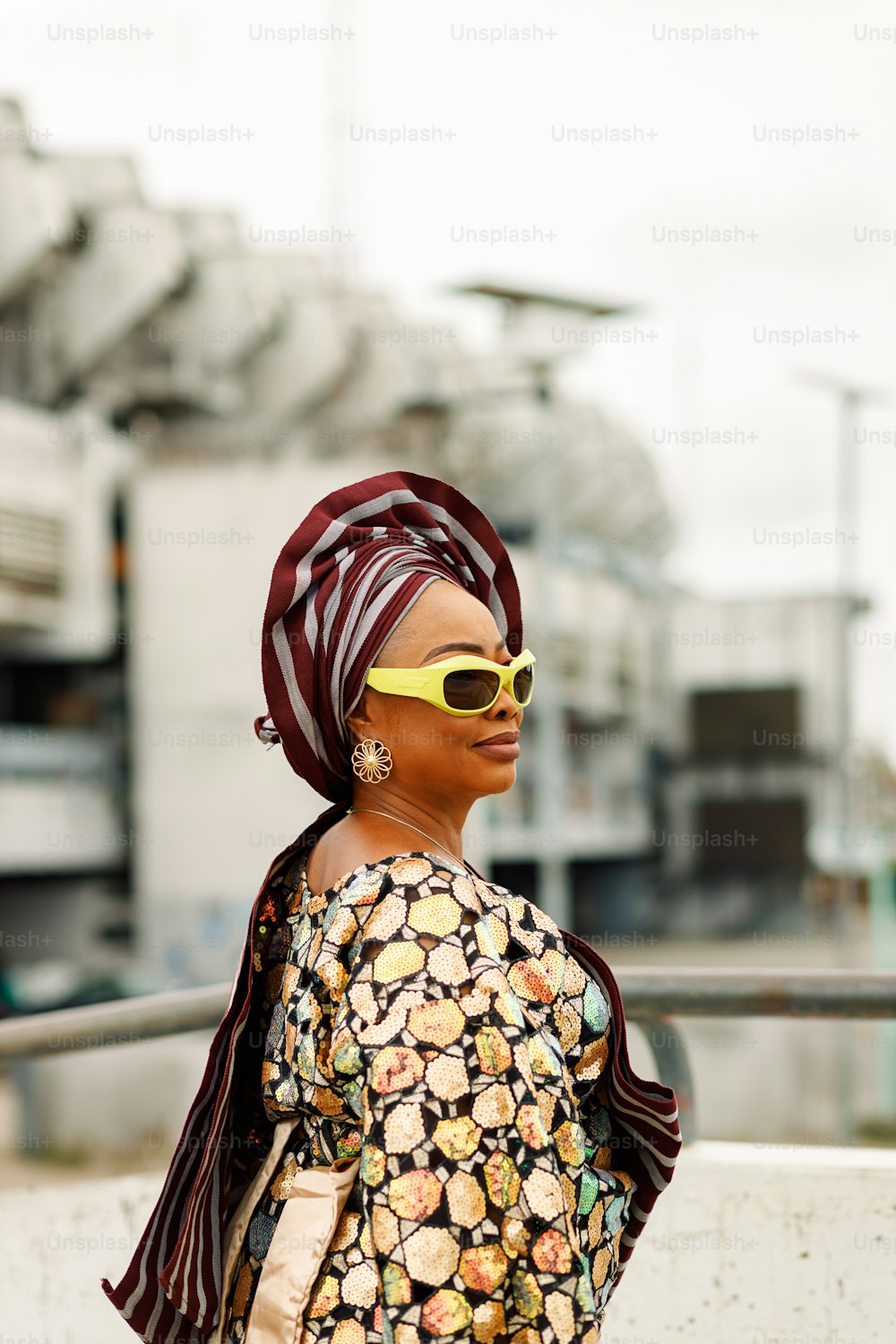 a woman with a scarf and sunglasses on