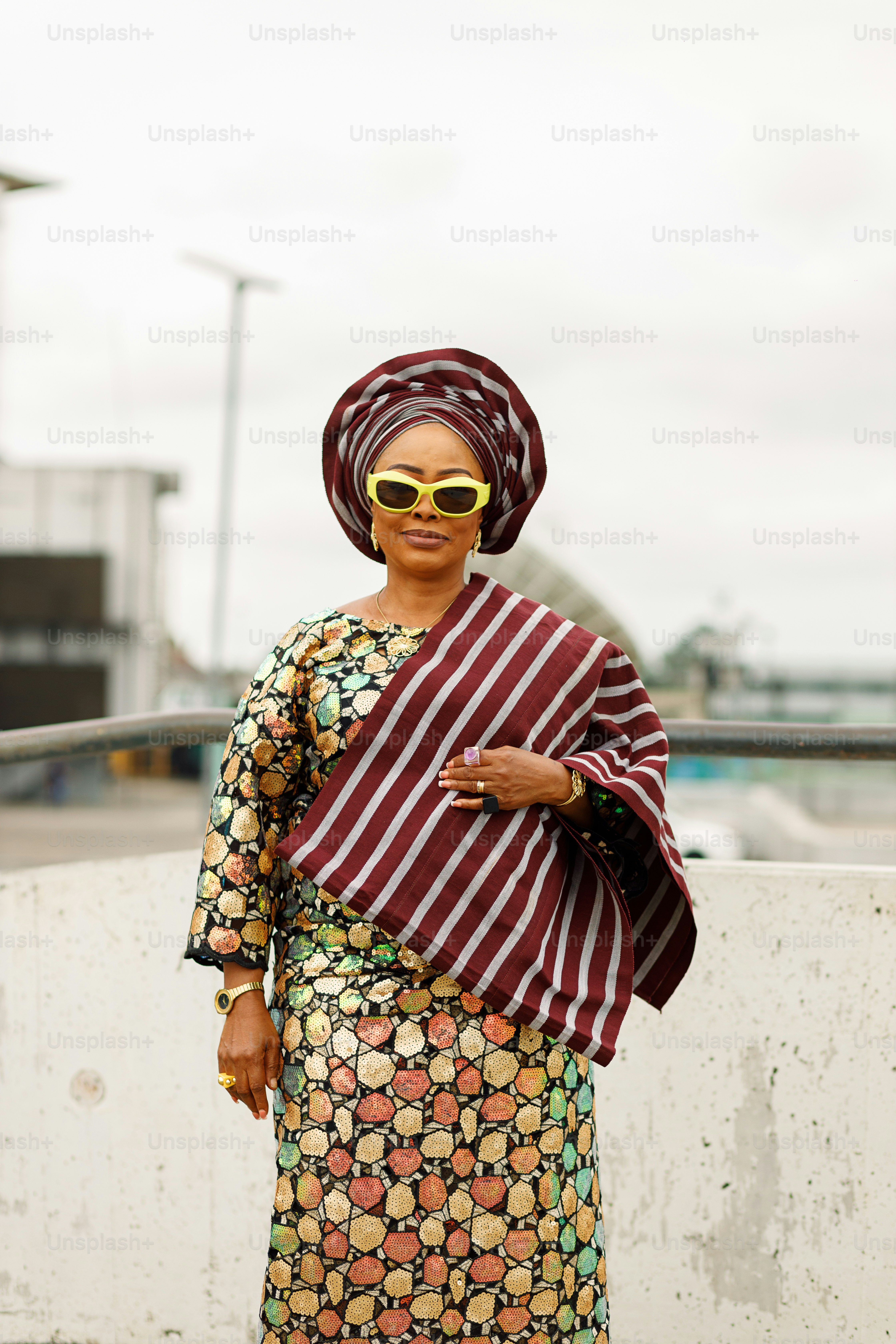 a woman in a colorful dress and sunglasses