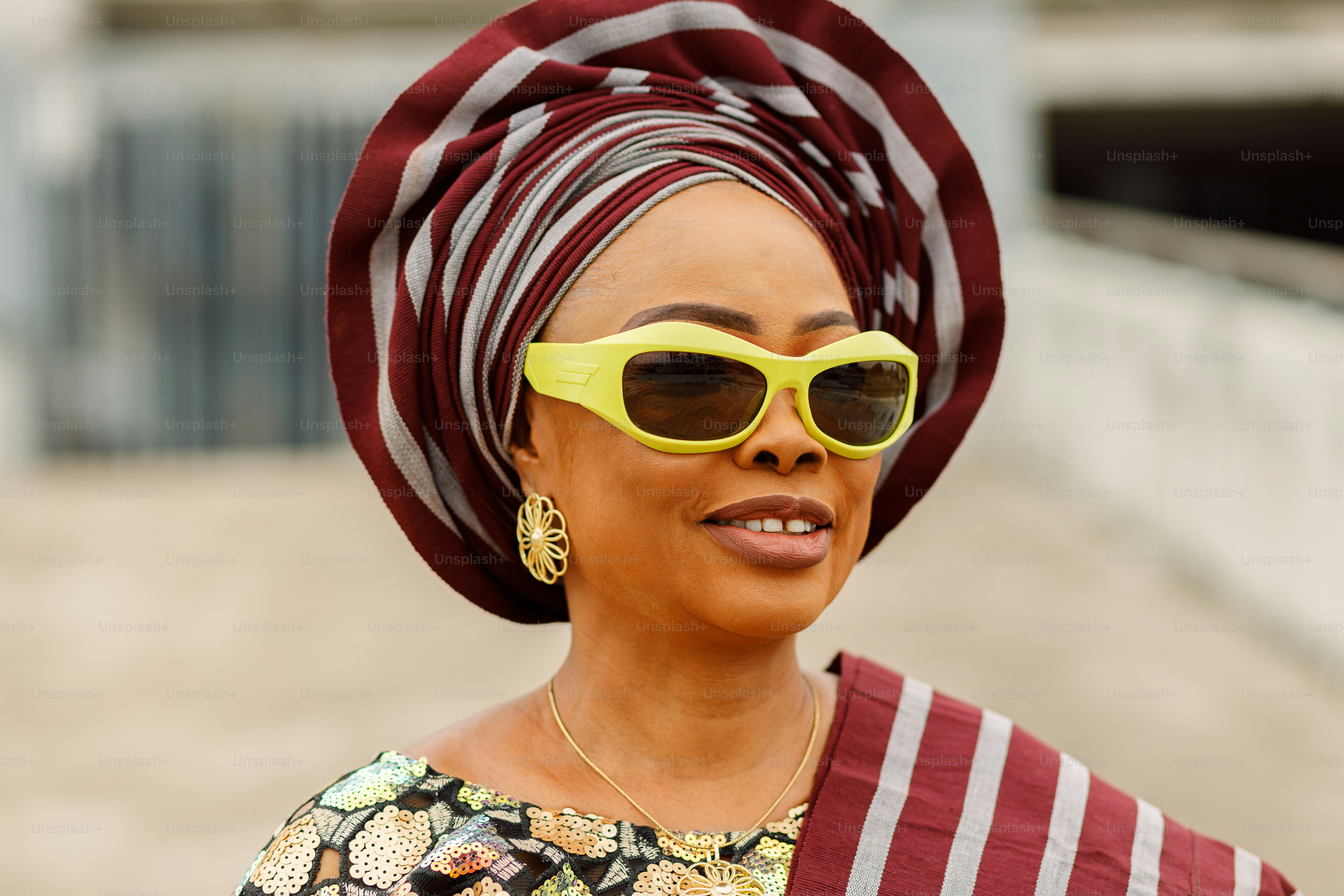A woman wearing a head scarf and sunglasses photo – Lagos Image on Unsplash