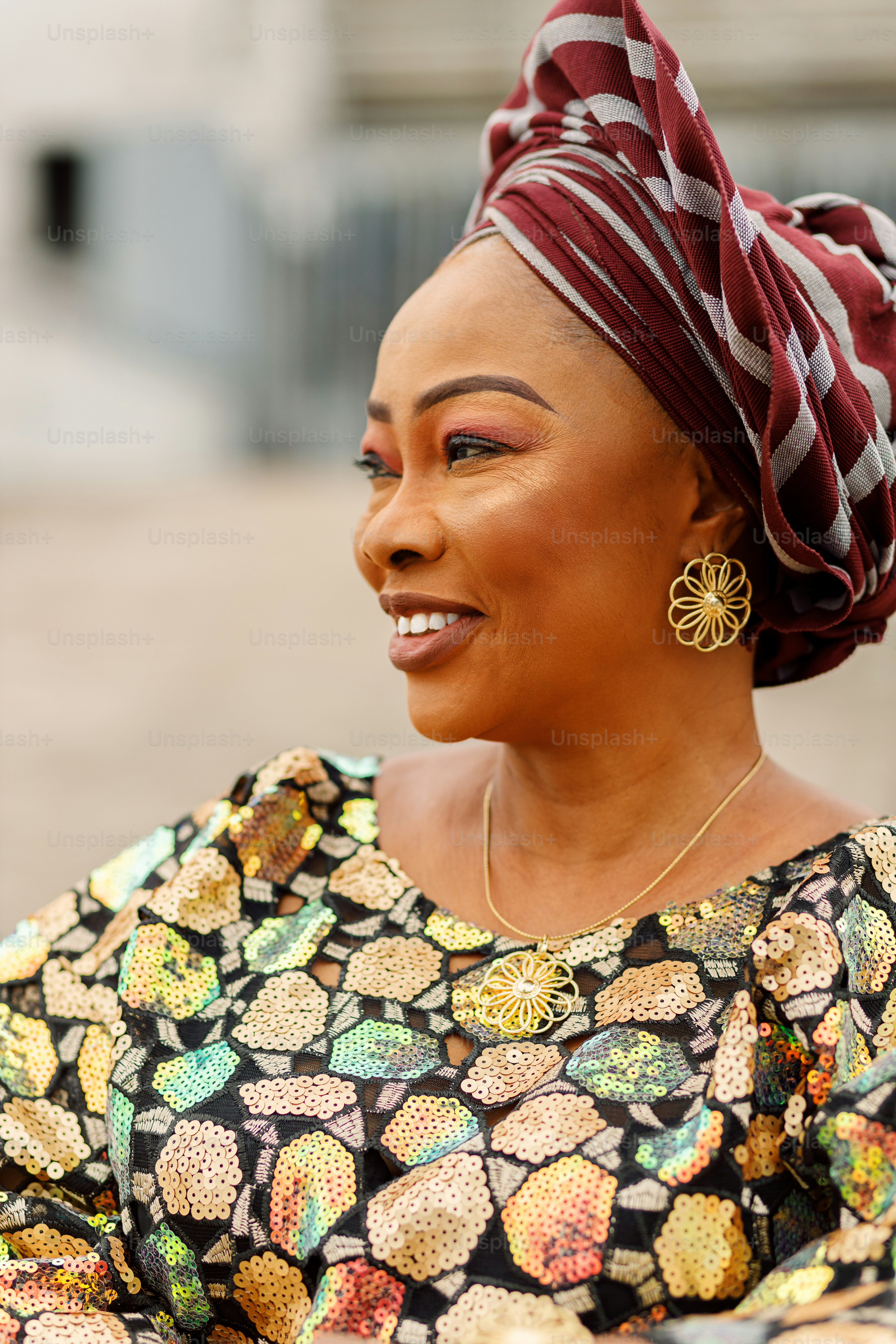 a woman wearing a colorful dress and a head scarf