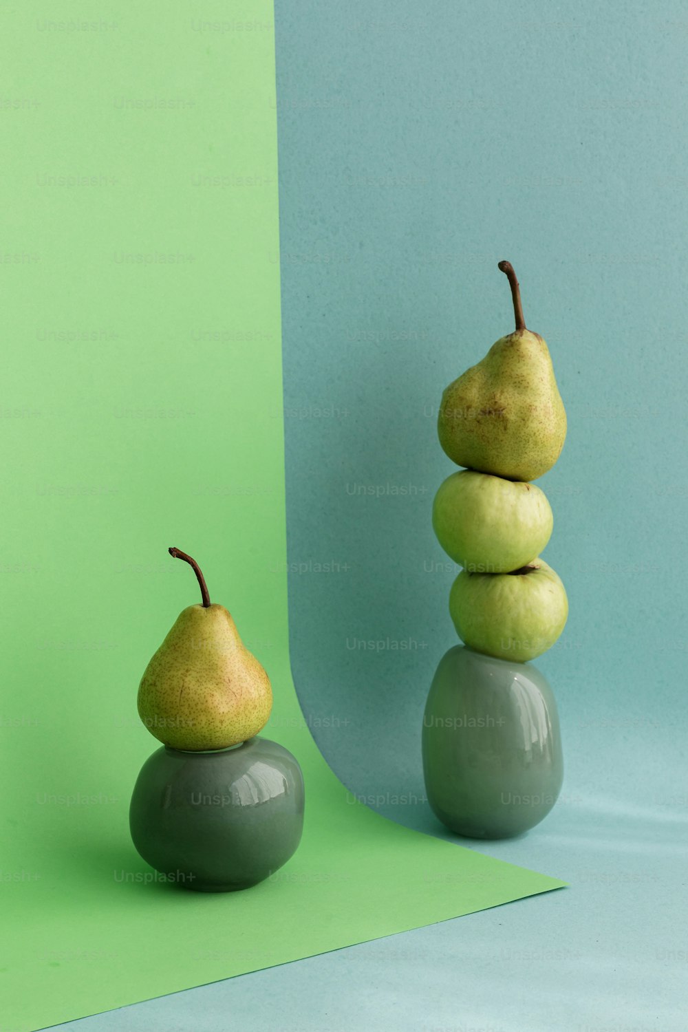 a couple of pears sitting on top of each other