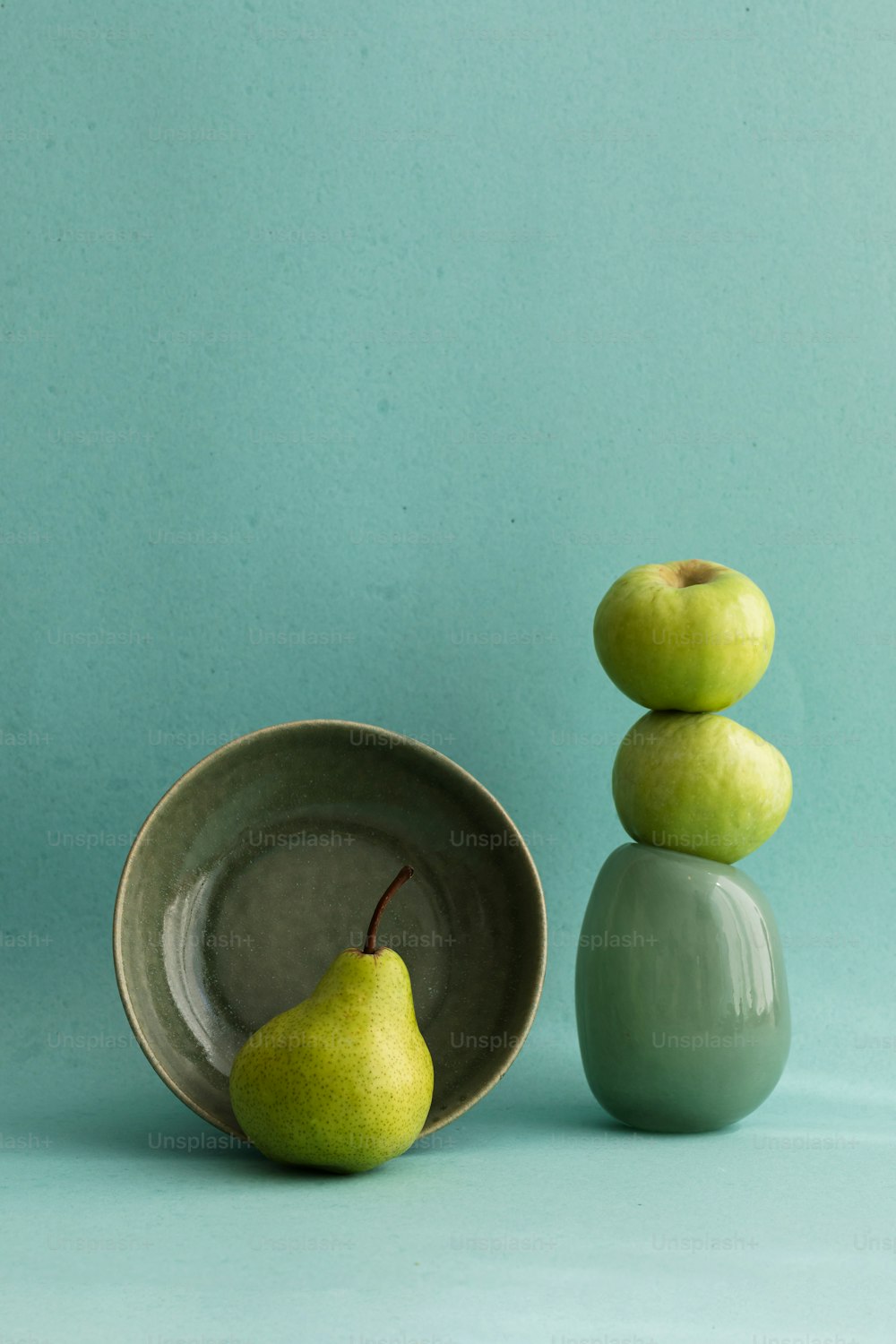 a bowl with two pears on top of it