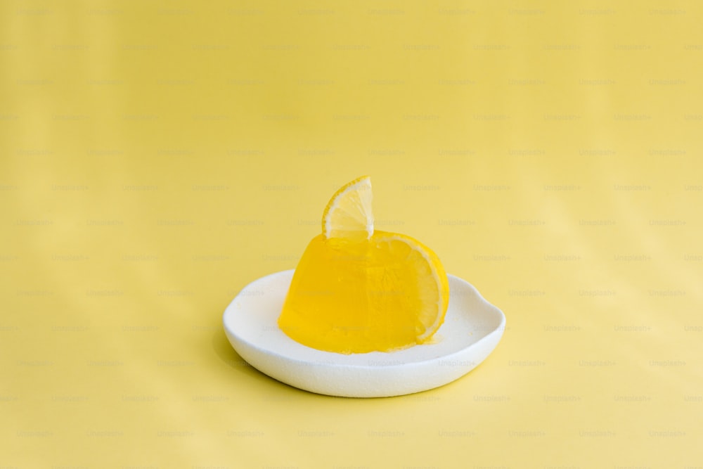 a slice of lemon sitting on top of a white plate